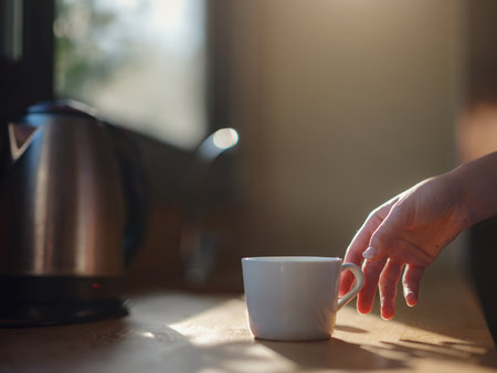 Woman is drinking coffee, morning routine. Tiny house. First property. Small apartment interior design. minimalism. moving in. living alone. Charming trailer house with the morning sunの写真素材