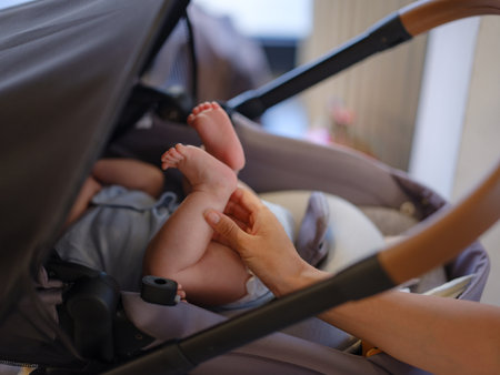 Diverse people portrait. Creative businesswoman balancing work and motherhood. Beautiful young mother working with laptop computer and breastfeeding, holding and nursing her newborn baby at cafe.の写真素材