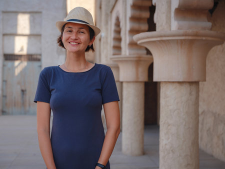 tourist trip to old Dubai, UAE. Asian Woman tourist in old narrow streets of Bur Dubai and Creek, Al Seef Heritage Souq. Travel and sightseeing journey conceptの写真素材