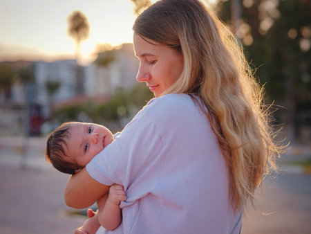 Diverse people portrait of mother with swarthy infant. mother and son on promenade in Antalya,...