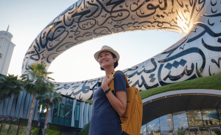 20 March 2023, Dubai, UAE: happy Tourist asian woman near Museum of The Future - New Attraction in...
