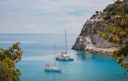 Anthony Quinn bay with crystal clear water and Luxurios yacht in Rhodes island, Greece. The most beautiful beach and Popular tourist attraction at Rhodes island. Sea travel and summer paradise conceptの写真素材