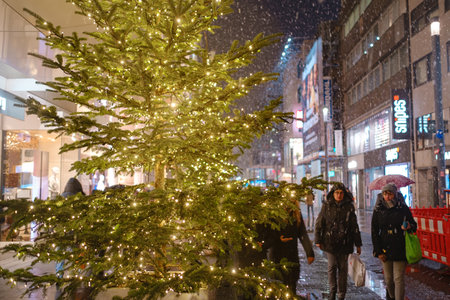 Dusseldorf. GERMANY. 13 DECEMBER 2022. The Christmas in Germany. Christmas market spirit. Celebrating Xmas holidays. Lights, carousel, small houses at market in city center with amazing food selectionのeditorial素材