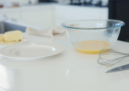 home work in white modern kitchen. woman preparing omelette with cheese, healthy and balanced...