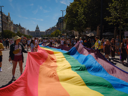Prague, Czech Republic - August 12, 2023: Prague Pride Festival Parade. People holding huge rainbow flag ot the Prague Gay Pride parade. Crowd on Wenceslas Square in front of the National Museum.のeditorial素材