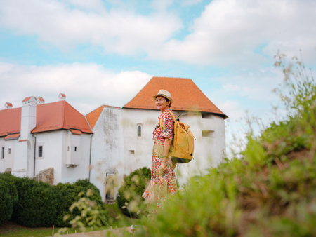 Beautiful woman walking of Varazdin streets during summer day in old, historical city center. Panorama and Cityscape of famous Croatian fortress town in Europe in summer. Travel and tourismの写真素材