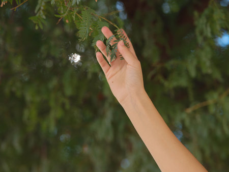 Young woman exploring Qasr Al Hosn Park in Abu Dhabi. Surrounded by lush greenery and historical landmarks, she enjoys the serene atmosphere and Emirati heritage in the heart of the city.の写真素材