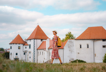 Beautiful woman walking of Varazdin streets during summer day in old, historical city center. Panorama and Cityscape of famous Croatian fortress town in Europe in summer. Travel and tourismの写真素材