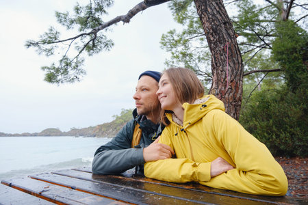 Couple enjoys Turkish coastline. walking in stone beach, watching sea waves, relaxing together, slow...