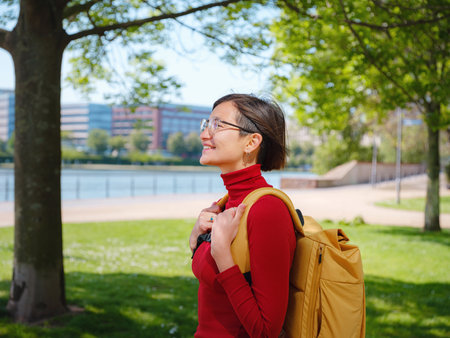 Tourist woman explores modern Frankfurt, walking through vibrant streets with contemporary...