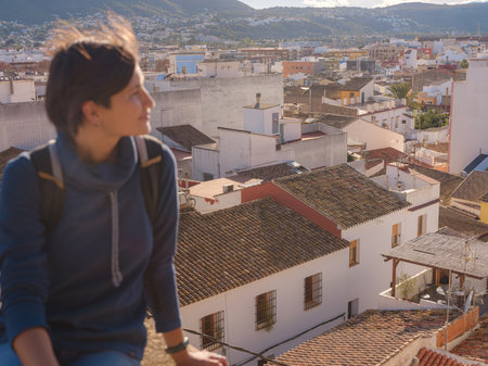 Young woman exploring historic castle in Denia, Alicante province, Spain, scenic views of town...
