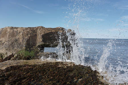 Summers day by the sea in Northern Britain.  Sea spray and wavesの写真素材