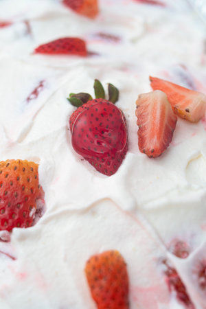Strawberry ice cream with whipped cream and fresh strawberries on topの写真素材