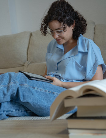 Woman reading an e-book in the living room