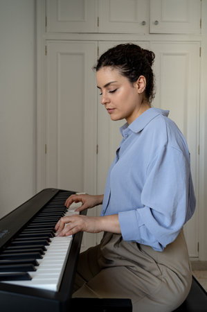 Beautiful woman playing the piano aloneの写真素材