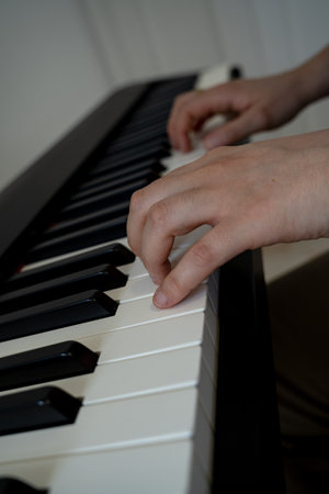 Hands of a woman playing the piano aloneの写真素材