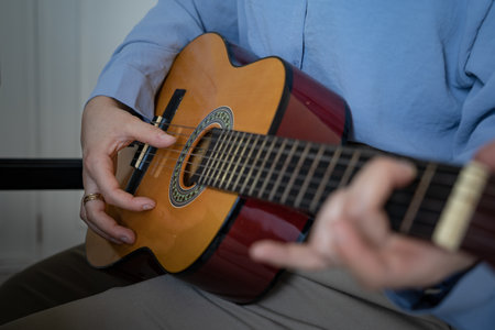 Woman playing the guitar close up viewの写真素材