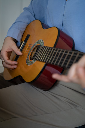 Woman playing the guitar close up viewの写真素材