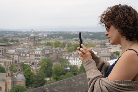 Woman taking pictures with phoneの写真素材