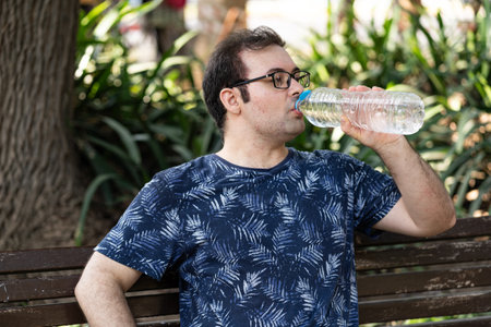 Young man drinking a bottle of waterの写真素材