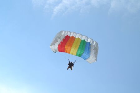 Skydiver skydiving with colourful parachute in rainbow coloursのeditorial素材