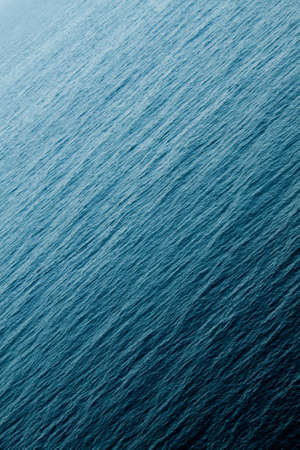 Ocean view from above small waves tilted portraitの写真素材