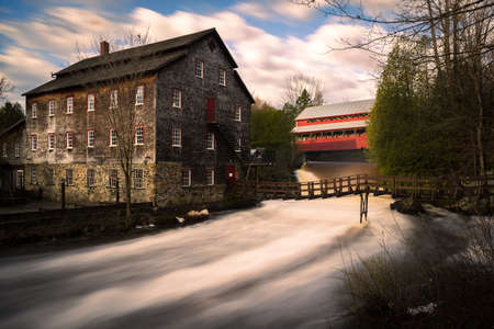 ulverton municipality wool mill, with its red wooden covered bridge.の写真素材