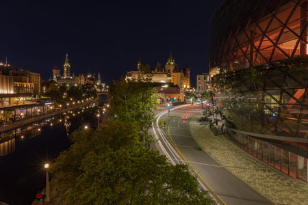 the Ottawa Convention Centre, at sunset, with Parliament and the Rideau Canal in the backgroundのeditorial素材
