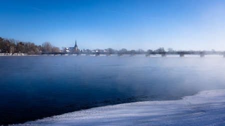 St-Athanase Church in Iberville facing a misty Richelieu River on a winter afternoonの写真素材