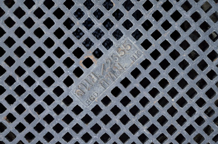 EXTREMELY CLOSE UP TO WATER VALVE COVER WITH TEXTURE BACKGROUND