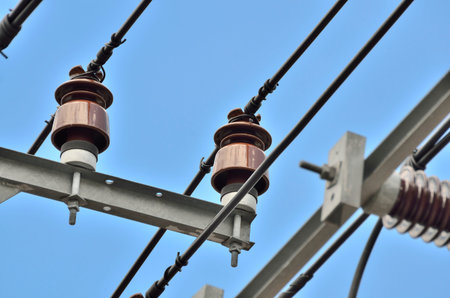 PORCELAIN INSULATOR - POST TYPE INSULATORS IN NATURE DAY LIGHT (SELECTIVE FOCUS)