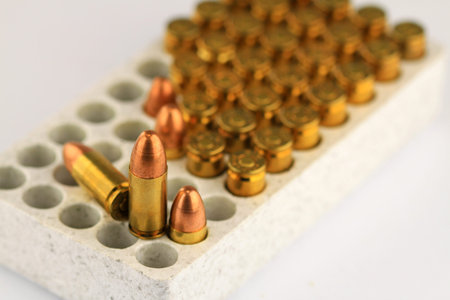 Live 9mm pistol round against white 