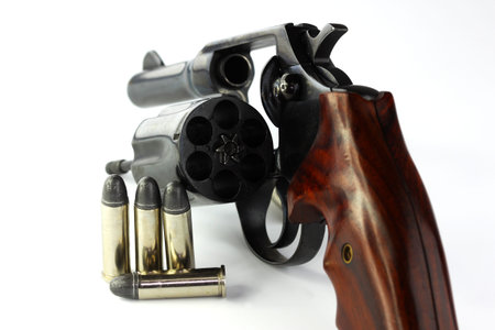 Close up of handgun revolver with bullets 
