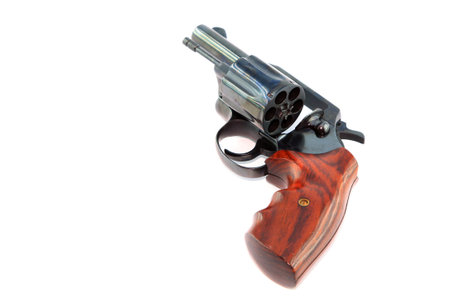 Black revolver gun on white background 