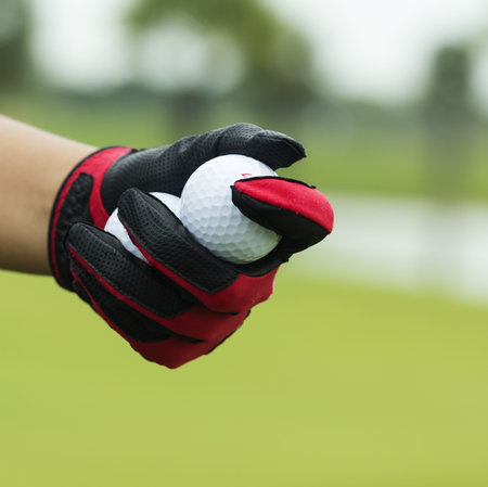 Close-up hand hold golf ballの写真素材