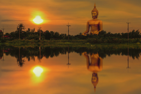 Big buddha statue in sunset at Angthong,Thailand の写真素材