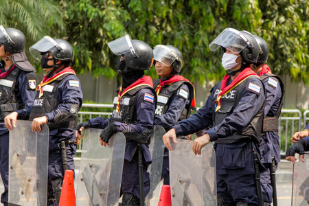 BANGKOK - NOV 13: Riot police stand guard near parliament during anti-government rally on Nov 13,...