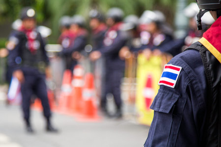 BANGKOK - NOV 13: Riot police stand guard near parliament during anti-government rally on Nov 13,...