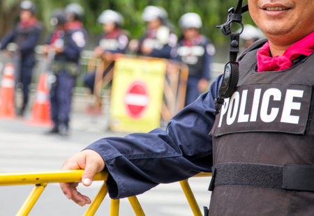 BANGKOK - NOV 13: Riot police stand guard near parliament during anti-government rally on Nov 13,...