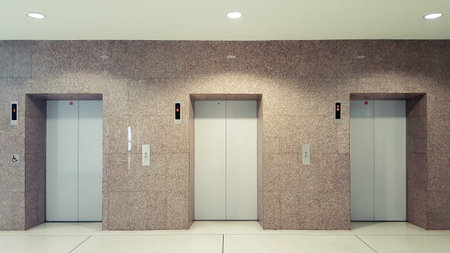 Open and closed chrome metal office building elevator doors realistic photo. Lift transportation...