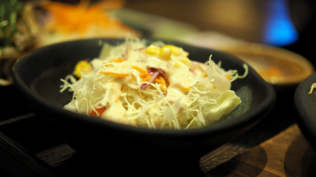 Lettuce salad in a black bowl.の写真素材