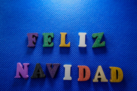 Colorful word on blue background composed from colorful wooden letters.の写真素材