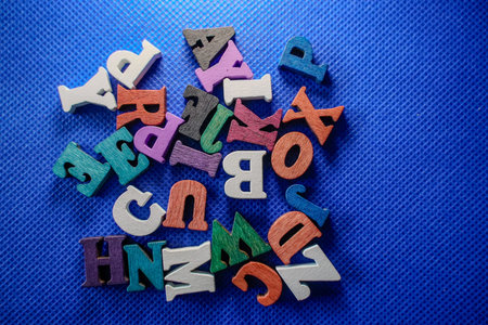 Wooden alphabets on blue background. Education concept.の写真素材