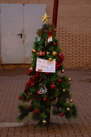 Christmas tree, placed on a crooked street lamp, with a sign that says, put up your ornament, saved from Dana, a month after the Valencia floods, in Paiporta, on December 3, 2024の写真素材
