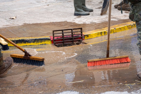Cleaning the streets with water and brushes, soldiers and firefighters, all united, clean the streets and sidewalks of the towns affected by Dana de Valenciaの写真素材