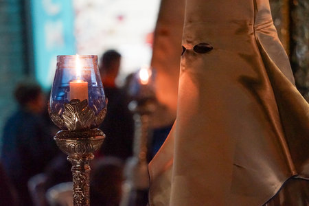 Nazarenes in white, with a lantern and a candle, to illuminate the streets of Cartagena, in the Holy...
