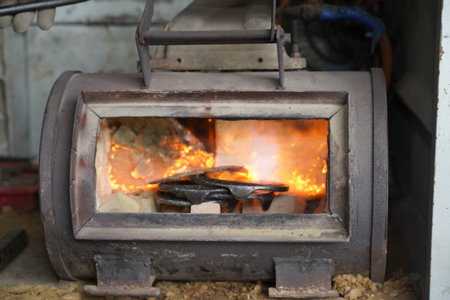 heating the horseshoes in a furnace, with flames in the backgroundの写真素材