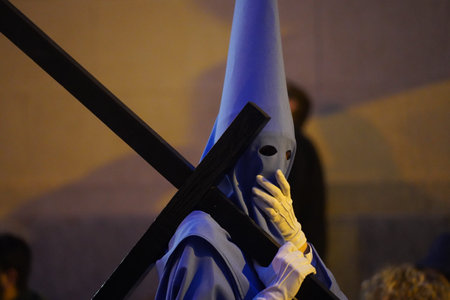 Penitent with a cross on his shoulder, makes his procession through the streets of the city