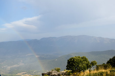 Rainbow between mountains, after a stormy afternoon, the sun comes out a little, with Sierra EspuÃ±a in the backgroundの写真素材