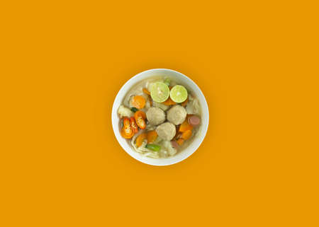 Meatball soup on a wooden cutting board with napkins on a white background.の写真素材